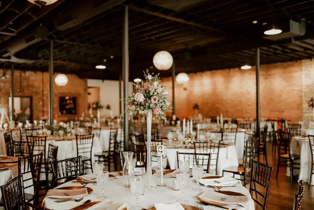 Brickyard on Main reception with brick walls and chiavari chairs
