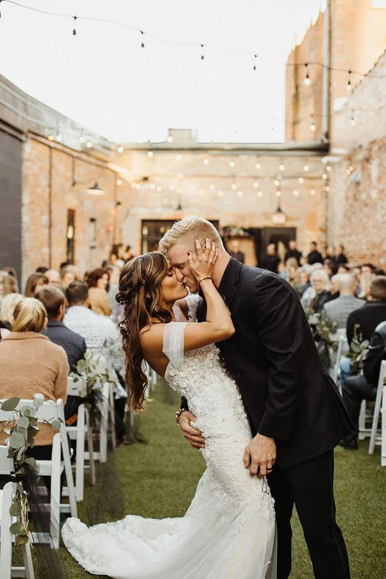 Couple's first kiss in the Brickyard courtyard