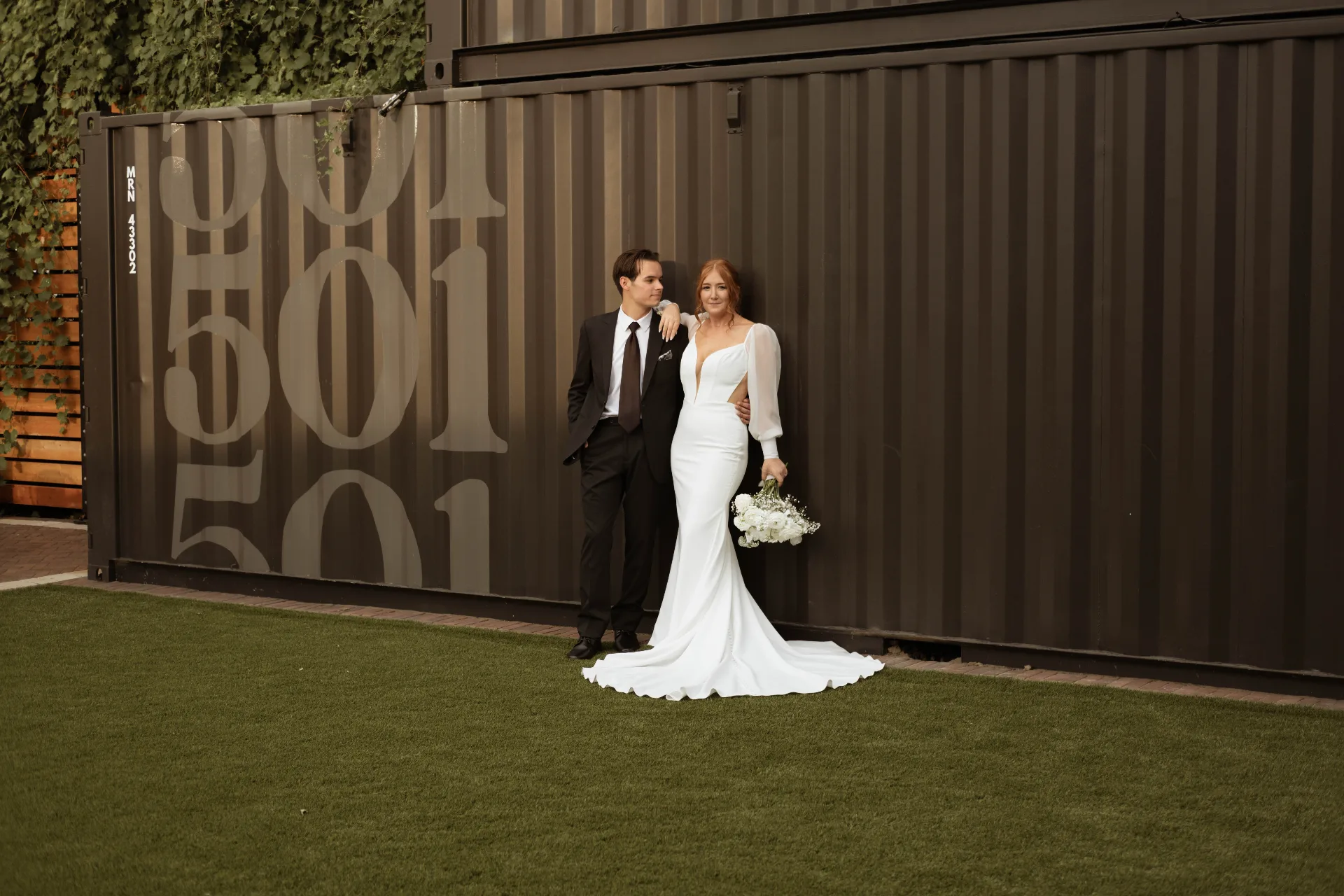 Couple kissing at the Passenger + Rail Co. bar at Urban501