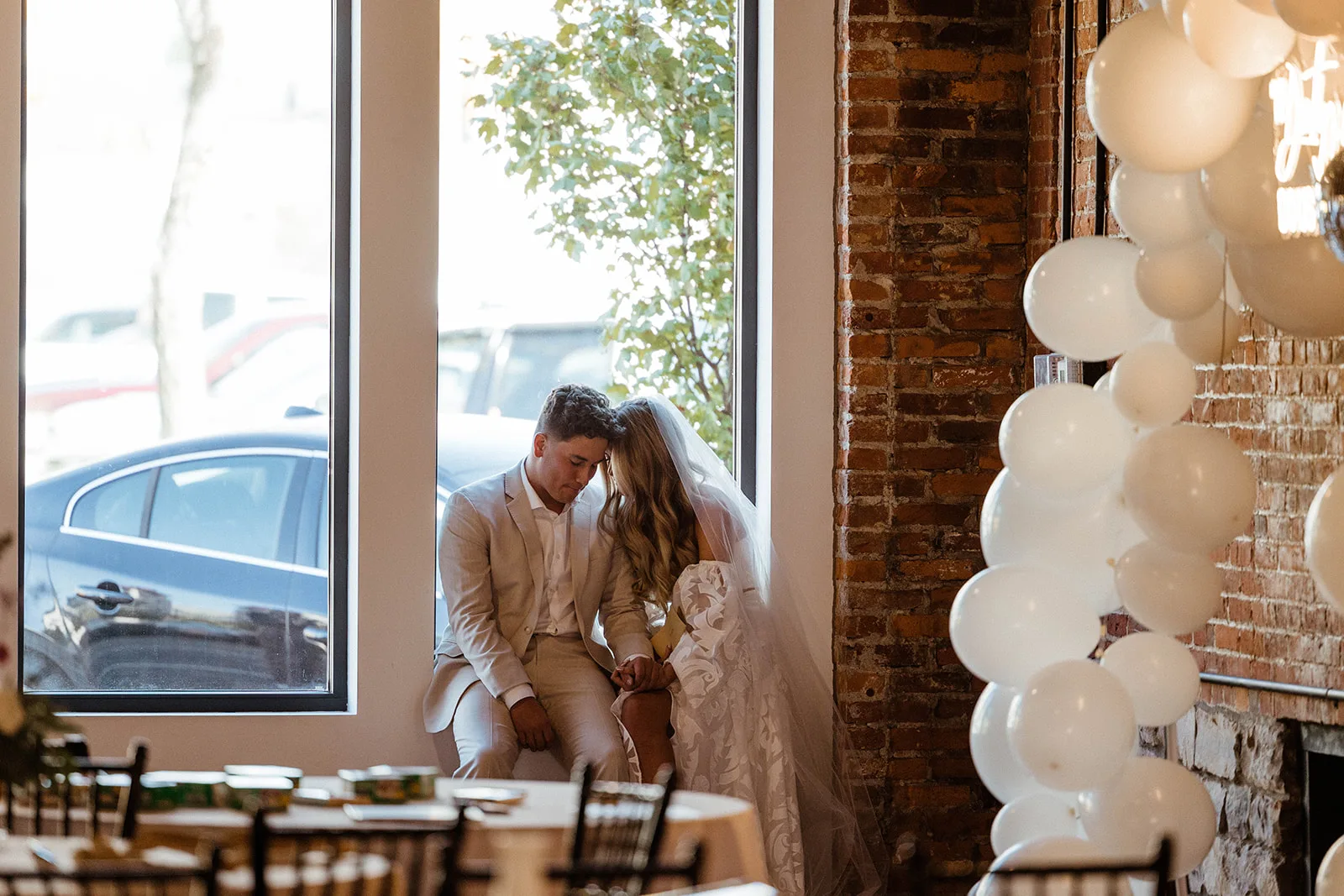 Couple sharing a quiet moment by the window at Brickyard on Main