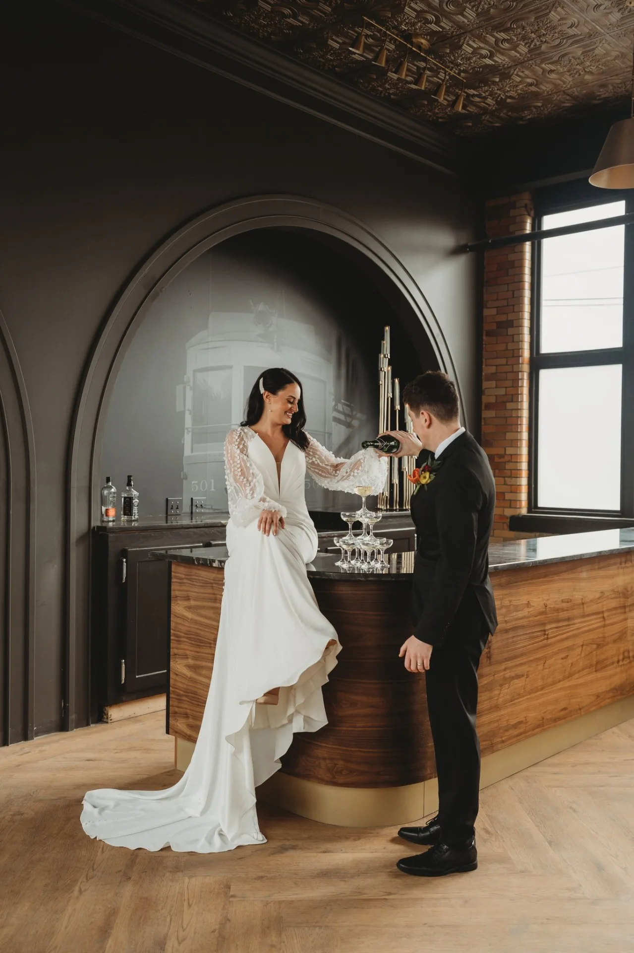 Bride and groom with champagne tower at the Urban501 bar