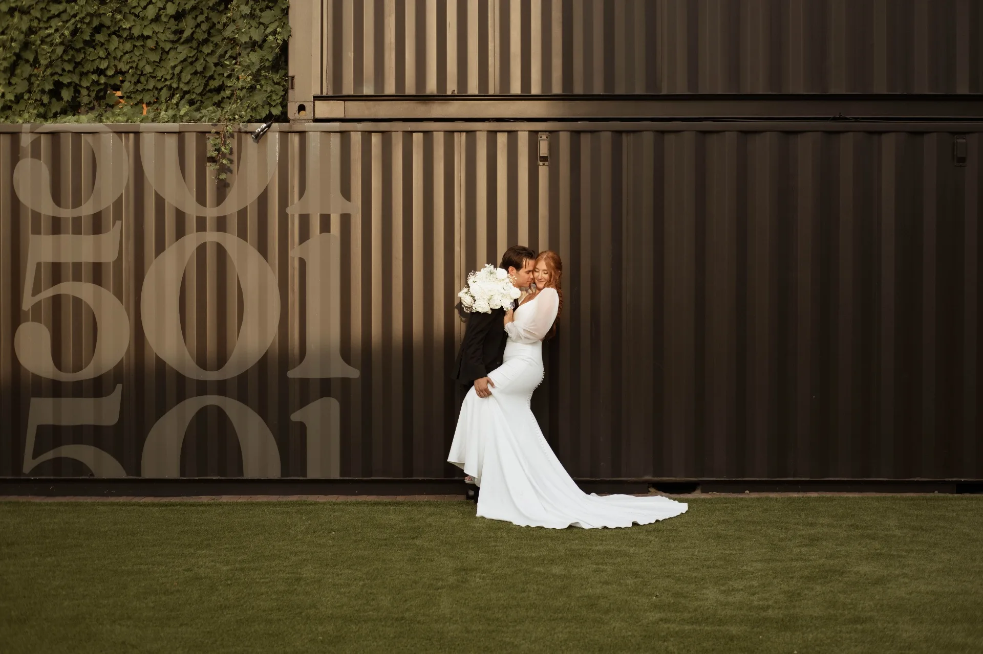 Couple by the 501 container wall at Urban501
